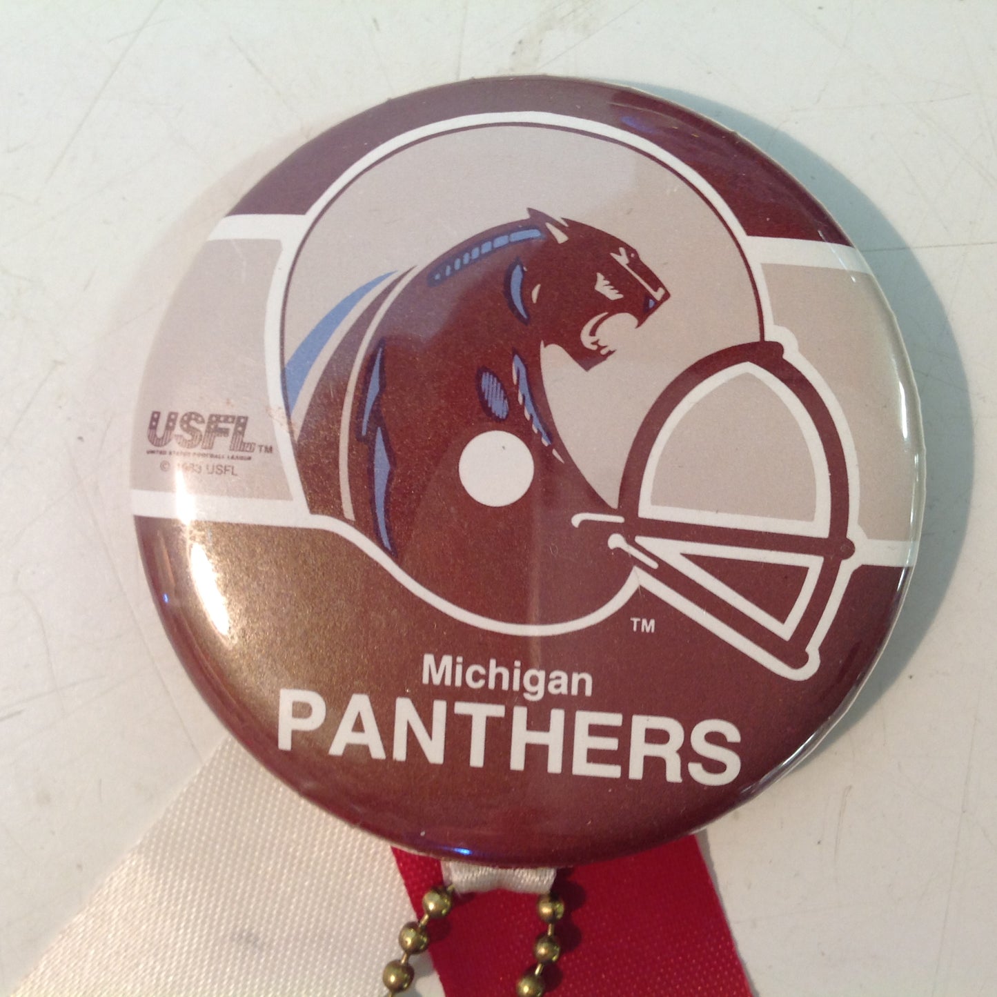 Vintage Michigan Panthers USFL Football Team Pinback with Ribbon and Maroon Rabbit Foot Flair