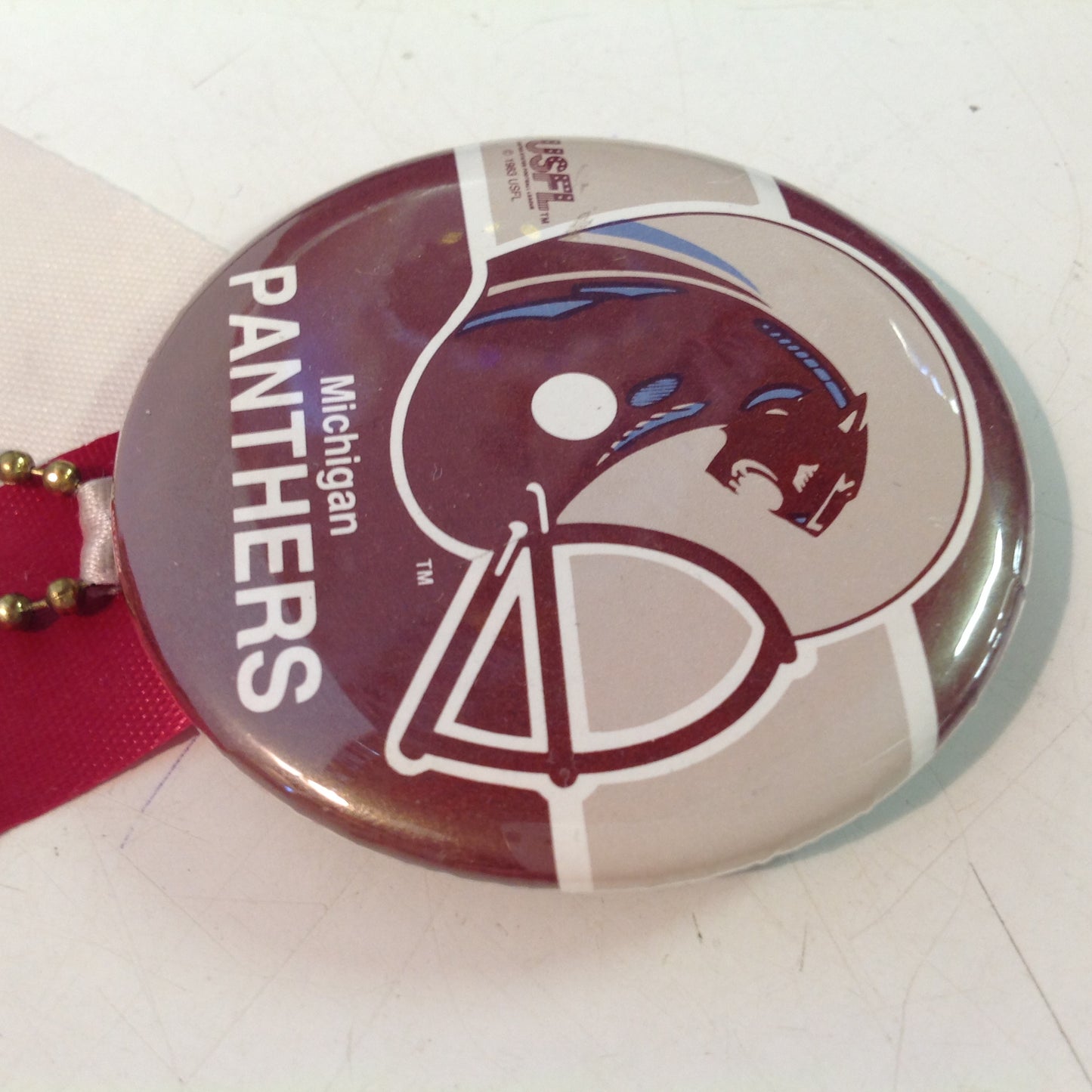 Vintage Michigan Panthers USFL Football Team Pinback with Ribbon and Maroon Rabbit Foot Flair