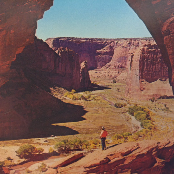 Vintage Color Postcard Man Standing Beneath The Window at Canyon de Chelly National Monument Chinle Arizona